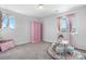 Charming bedroom featuring carpeted floors, two windows, and a pink wardrobe at 4009 Manorbrier Cir, Castle Rock, CO 80104