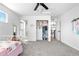 Bright bedroom with built-in storage, a ceiling fan, and a large window providing natural light at 4009 Manorbrier Cir, Castle Rock, CO 80104