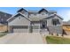 Beautiful two-story home with an attached three-car garage and landscaped front yard at 4009 Manorbrier Cir, Castle Rock, CO 80104