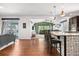 Open-concept kitchen with modern pendant lighting and decorative backsplash island seating at 4009 Manorbrier Cir, Castle Rock, CO 80104