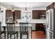 Charming kitchen with stainless steel appliances and sleek, dark wood cabinetry at 4009 Manorbrier Cir, Castle Rock, CO 80104