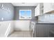 Bright laundry room featuring gray walls and white trim, with a window providing natural light at 4009 Manorbrier Cir, Castle Rock, CO 80104