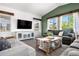 Comfortable living room featuring large windows, a cozy sofa, and stylish decor at 4009 Manorbrier Cir, Castle Rock, CO 80104
