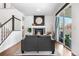 Cozy living room with a fireplace, staircase, hardwood floors, and sliding glass doors at 4009 Manorbrier Cir, Castle Rock, CO 80104