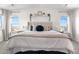 Bright main bedroom showcasing a large bed, two windows, and tasteful decorations at 4009 Manorbrier Cir, Castle Rock, CO 80104