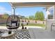 Covered patio with a comfortable egg chair and view of the landscaped backyard at 4009 Manorbrier Cir, Castle Rock, CO 80104
