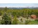 Expansive backyard with mountain views showcasing a shed and abundant trees at 401 Highway 72, Golden, CO 80403