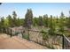 Outdoor balcony offering an expansive view of the surrounding lush green forest at 401 Highway 72, Golden, CO 80403