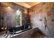 Luxurious bathroom showcasing stone walls, an elegant soaking tub, and stylish fixtures at 401 Highway 72, Golden, CO 80403