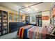 Serene bedroom featuring a canopy bed, two windows and well-lit bookshelves at 401 Highway 72, Golden, CO 80403