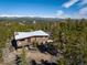 Home exterior with scenic mountain views in the background, surrounded by lush greenery and mature trees at 401 Highway 72, Golden, CO 80403
