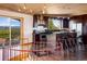 Modern kitchen with stainless steel appliances, a wooden ceiling, and mountain views from the balcony at 401 Highway 72, Golden, CO 80403