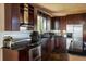 Well-equipped kitchen with modern appliances, dark cabinets, and stone tile floors at 401 Highway 72, Golden, CO 80403