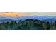 Panoramic landscape featuring snow-capped mountains in the distance, and the forest landscape in the foreground at 401 Highway 72, Golden, CO 80403