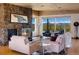 Cozy living room featuring a stone fireplace, comfortable seating, and panoramic mountain views at 401 Highway 72, Golden, CO 80403