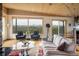 Bright living room featuring large windows with mountain views, hardwood floors and a comfortable sofa at 401 Highway 72, Golden, CO 80403