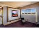 Cozy bedroom with a large picture window framing mountain views and a chair for relaxing at 401 Highway 72, Golden, CO 80403