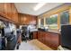 Functional home office with ample workspace, storage cabinets, and natural light from the window at 401 Highway 72, Golden, CO 80403
