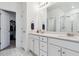 Bright bathroom boasts double vanity, modern fixtures, and a glass-enclosed shower at 18304 Caffey Dr, Parker, CO 80134