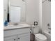 Bathroom featuring a single sink vanity, toilet, and shower-tub combination with tile surround at 18304 Caffey Dr, Parker, CO 80134