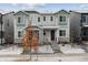 Charming two-story townhome with stylish gray exterior, stone accents, and a welcoming front porch at 18304 Caffey Dr, Parker, CO 80134