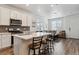 Modern kitchen with white cabinets, stainless steel appliances, and a spacious island with barstool seating at 18304 Caffey Dr, Parker, CO 80134