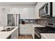 Well-equipped kitchen featuring stainless steel appliances, white countertops, and modern fixtures at 18304 Caffey Dr, Parker, CO 80134