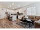 Open concept kitchen with white cabinets, stainless steel appliances, and seamless flow into the living area at 18304 Caffey Dr, Parker, CO 80134