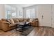 Cozy living room with a comfortable leather sectional, modern rug, and natural light at 18304 Caffey Dr, Parker, CO 80134