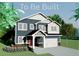 Two-story home with a neutral exterior, trim details, complemented by a two-car garage and a red front door at 670 S Jasper St, Aurora, CO 80017
