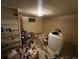 Unfinished basement with exposed shelving, small window, and white washer and dryer appliance at 841 S 6Th Ave, Brighton, CO 80601