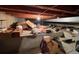 Unfinished basement with exposed ceiling beams and concrete walls; storage boxes at 841 S 6Th Ave, Brighton, CO 80601