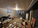 Unfinished basement with water heater, stairs to upper floor, and a small window with curtains at 841 S 6Th Ave, Brighton, CO 80601