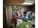 Unfinished basement with shelving, washing machine, dryer, and many stored personal items at 841 S 6Th Ave, Brighton, CO 80601
