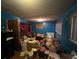 View of the cluttered bedroom with blue walls and a closet at 841 S 6Th Ave, Brighton, CO 80601