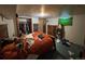 Bedroom with closet, dresser, mirror, and bed with orange comforter at 841 S 6Th Ave, Brighton, CO 80601