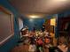 View of the cluttered bedroom with blue walls and a window at 841 S 6Th Ave, Brighton, CO 80601