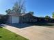 Exterior view featuring a ranch-style home, concrete driveway, attached one car garage and a front yard with mature trees at 841 S 6Th Ave, Brighton, CO 80601