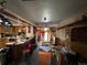Full kitchen featuring wood cabinetry, a bar top with seating, and access to the living area and backyard at 841 S 6Th Ave, Brighton, CO 80601