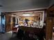 This kitchen features wooden cabinetry, an island with bar seating, and access to additional spaces at 841 S 6Th Ave, Brighton, CO 80601