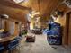 Large entertainment room featuring wood paneled walls, a pool table, an arcade game, and eclectic decorations at 841 S 6Th Ave, Brighton, CO 80601