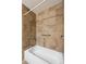 Close up of bathtub and tiled shower with accessible grab bars at 27124 Sun Ridge Dr, Evergreen, CO 80439