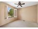Bright bedroom featuring a ceiling fan, carpeted floor, and bright natural light from the window at 27124 Sun Ridge Dr, Evergreen, CO 80439