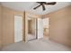 Neutral bedroom with mirrored closet doors, carpeted floor, and ceiling fan at 27124 Sun Ridge Dr, Evergreen, CO 80439