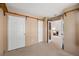 Well-lit bedroom with carpet, showcasing two closets and an open doorway leading into the living room at 27124 Sun Ridge Dr, Evergreen, CO 80439
