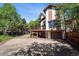 Two-story home with a deck above the garage and mature landscaping at 27124 Sun Ridge Dr, Evergreen, CO 80439