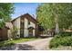 Front exterior view of a two-story home featuring a front entrance, driveway and surrounding landscape at 27124 Sun Ridge Dr, Evergreen, CO 80439