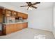 Open kitchen area with classic wooden cabinets and a breakfast bar at 27124 Sun Ridge Dr, Evergreen, CO 80439