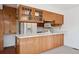 Functional kitchen with wooden cabinetry, sleek countertops, and modern appliances, seamlessly integrated at 27124 Sun Ridge Dr, Evergreen, CO 80439