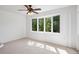 Bright living room with large windows offering a view of the surrounding trees at 27124 Sun Ridge Dr, Evergreen, CO 80439